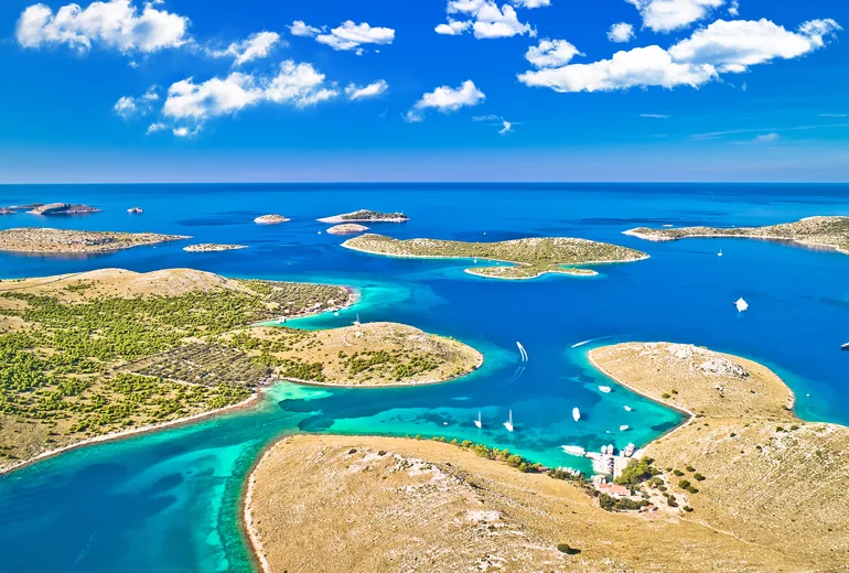Aerial of Kornati islands with turquoise lagoons and scattered anchored boats