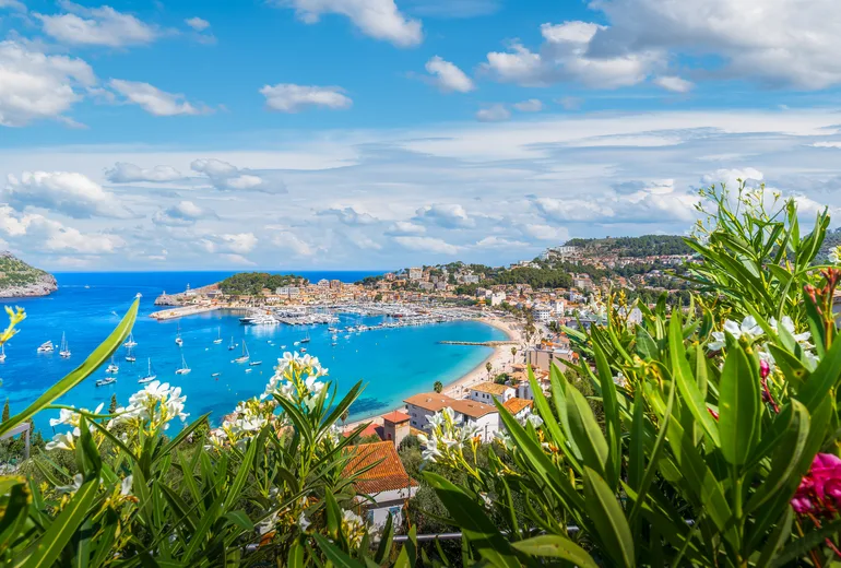 Port de Soller bay and town framed by oleander flowers, Mallorca, Spain