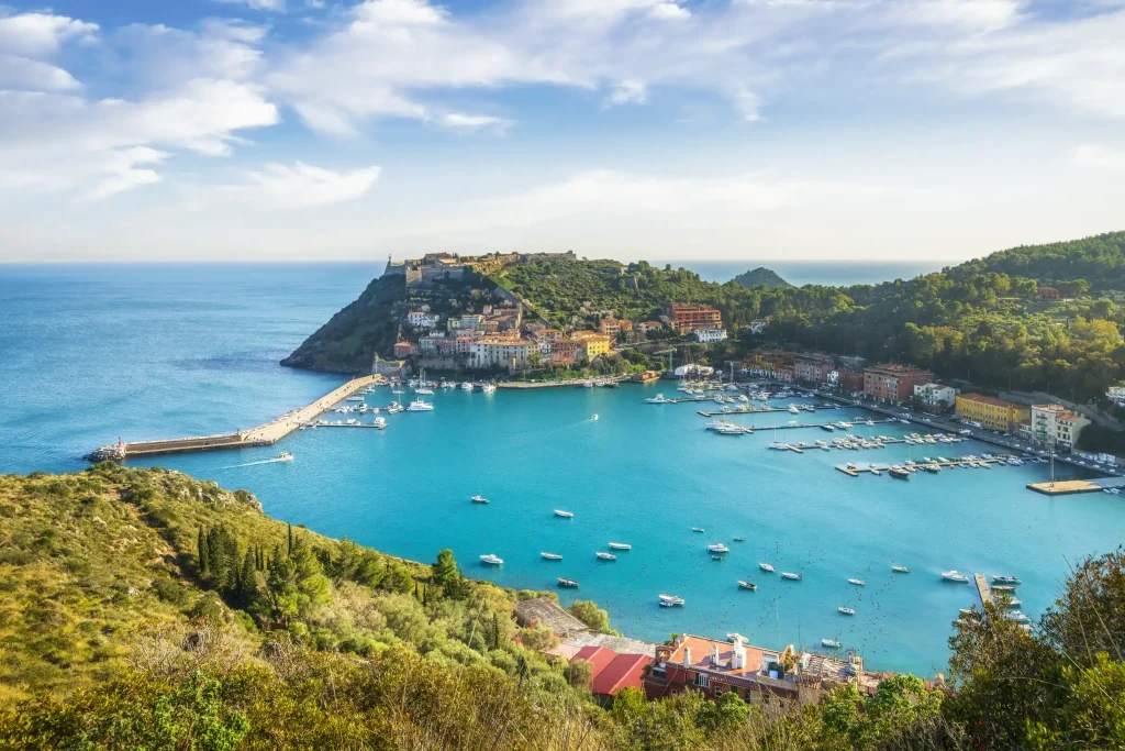 Porto Ercole bay with moored yachts and hilltop fortresses, Tuscany