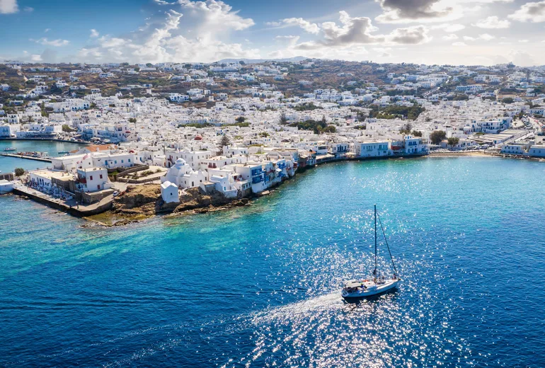 Sailboat approaching Mykonos town waterfront