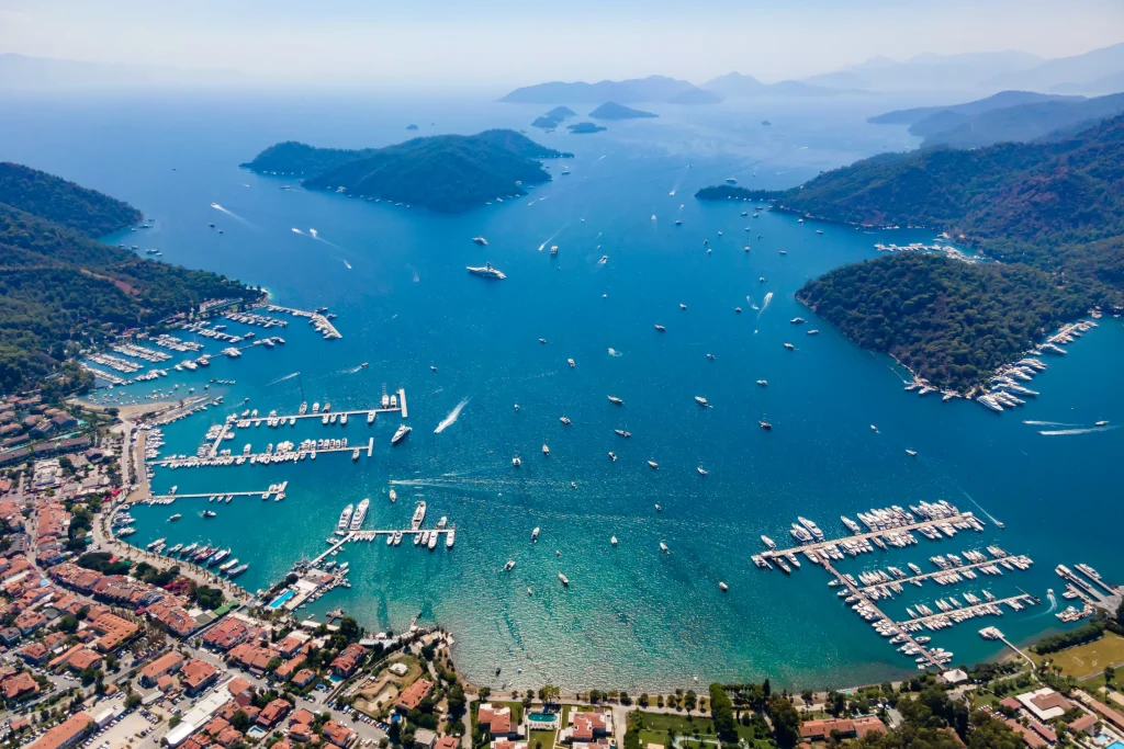 Sweeping aerial of Gocek bay, marinas full of yachts, town and pine islands