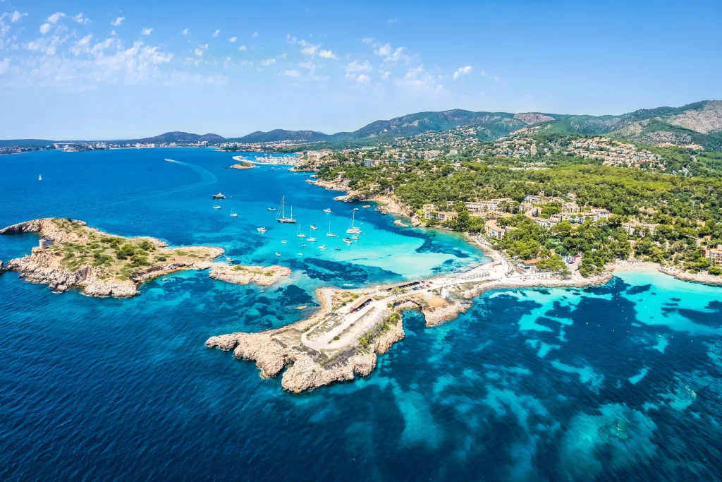 Aerial view of turquoise bays, islets and yachts along coast, Mallorca